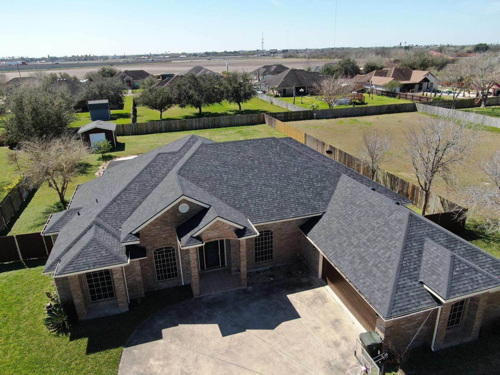 Close-up image of hail damage on roof shingles after storm.