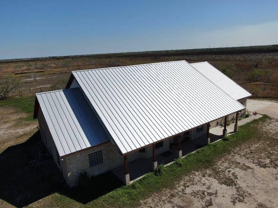 XYZ Roofing team installing new roof funded by insurance claim payout.