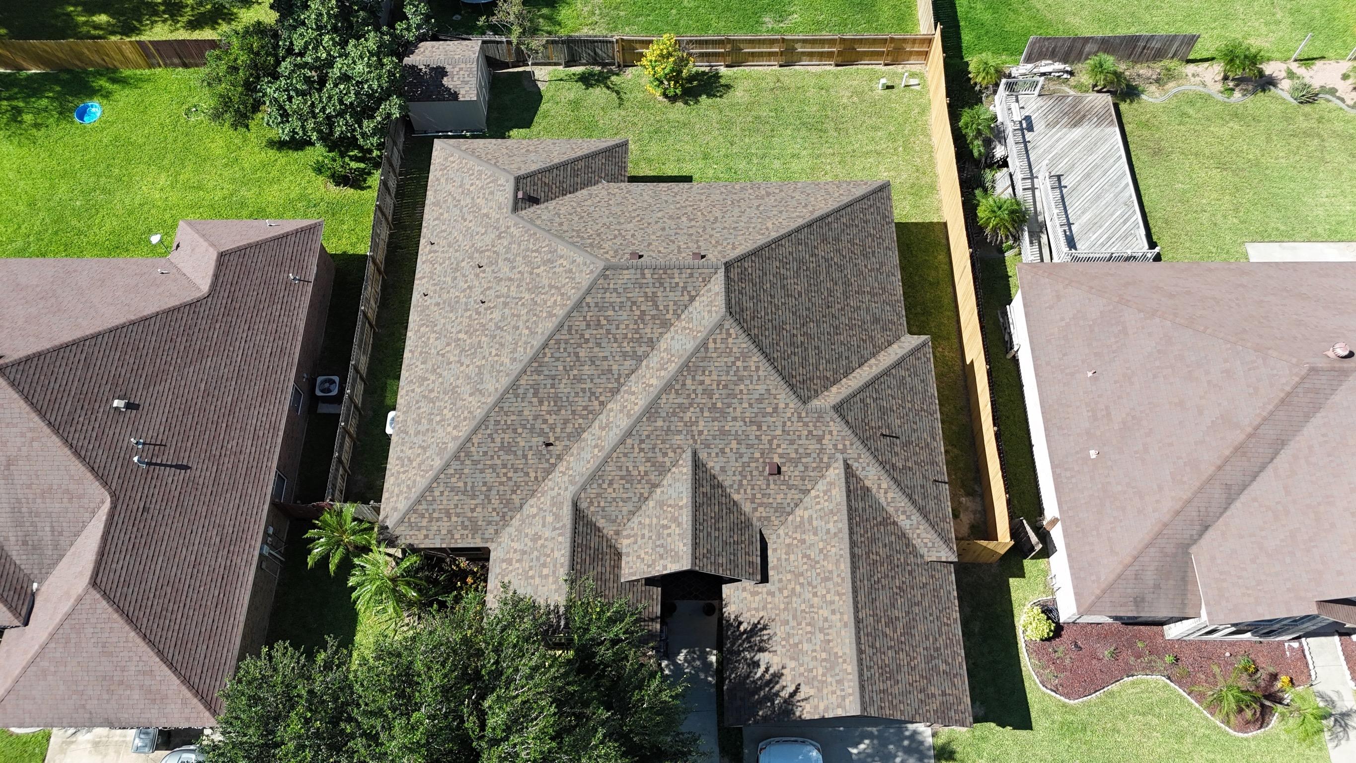 XYZ Roofing project manager reviewing roof installation.