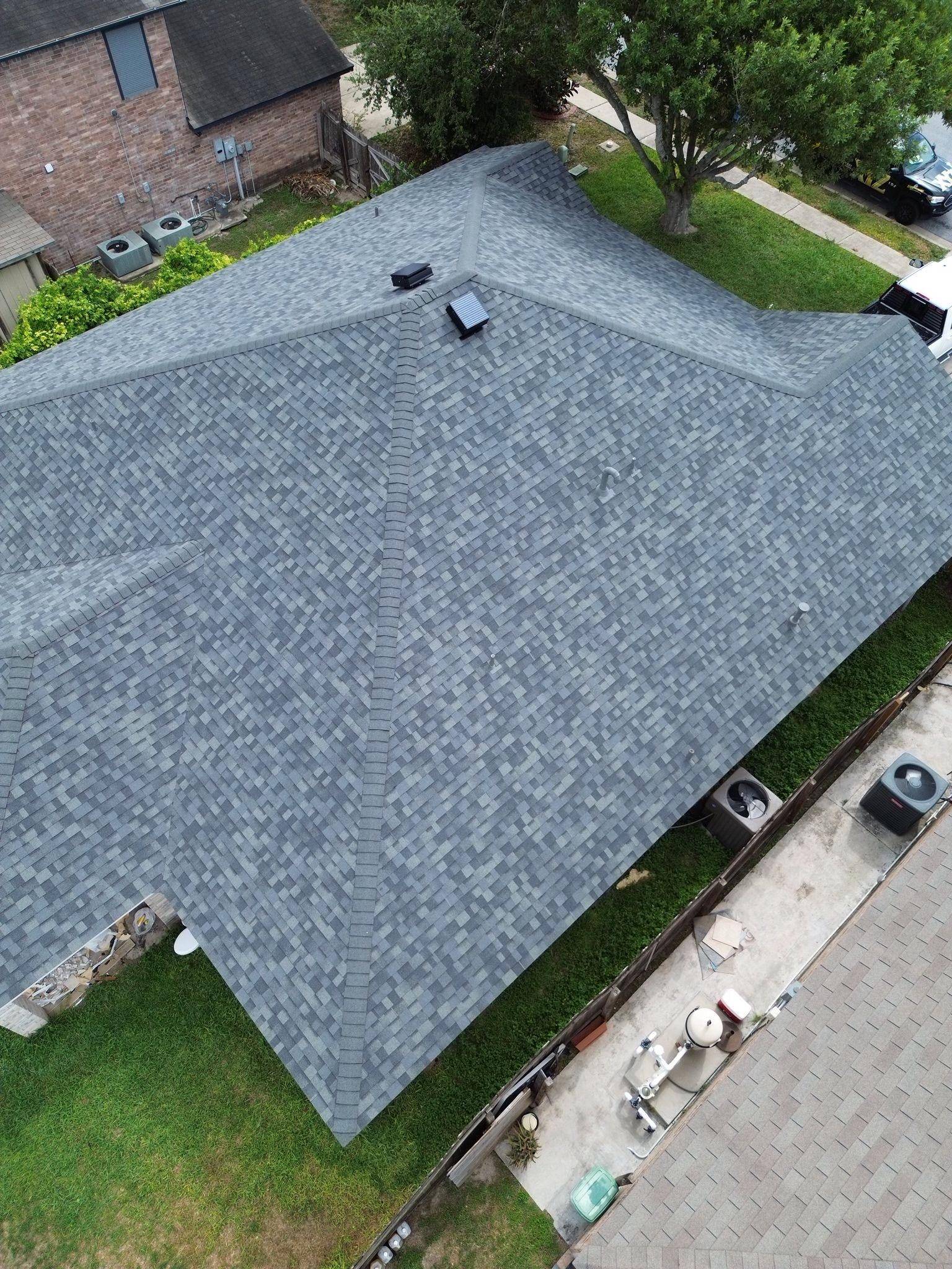 “Close-up of rotted roof decking discovered under old shingles on a Texas home”